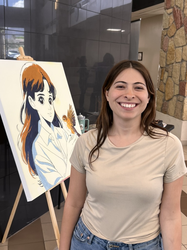 Raquel Madrigal beside the in-progress canvas on an easel